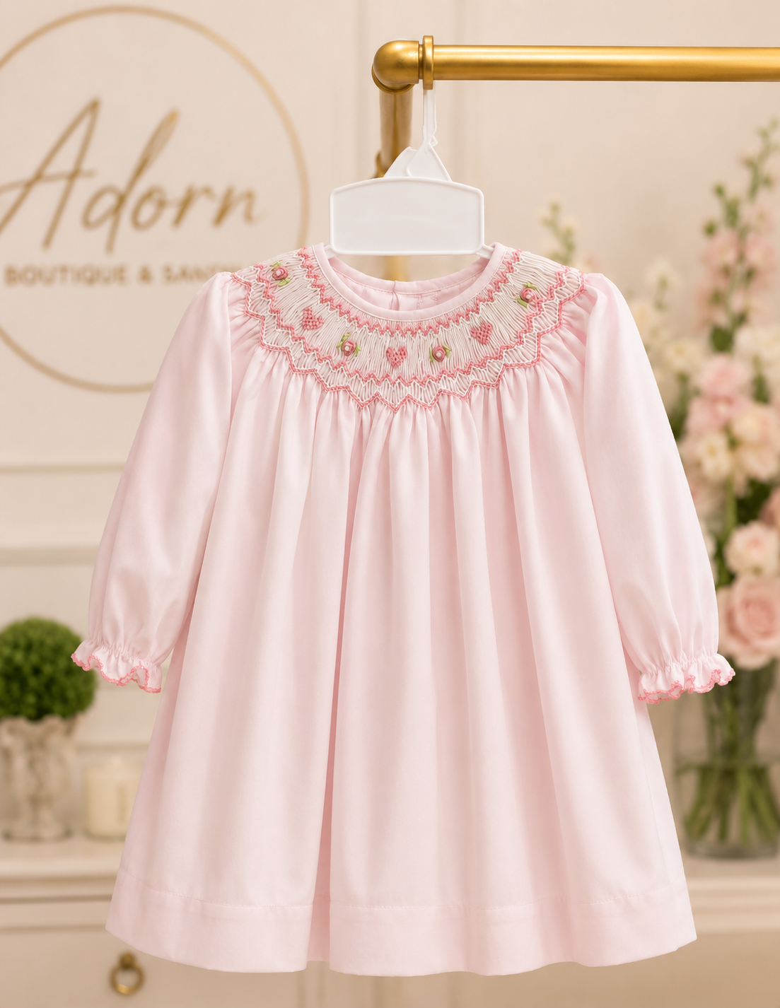 Pink smocked children's dress from Adorn Boutique and Salon